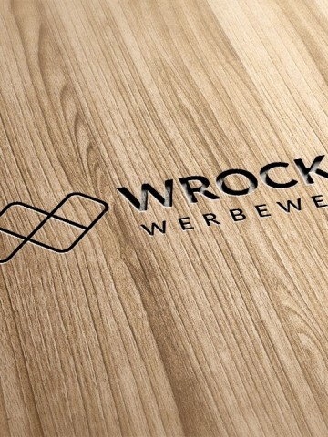 Logo-Gravur auf Holzoberfläche – hochwertige Materialveredelung mit Struktur und Tiefe Graviertes Wrocklage-Logo auf heller Holzoberfläche als Beispiel für Materialveredelung und Branding