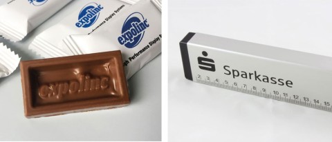 Verschiedene Werbeartikel, darunter Lanyards, LKW-Modell-Verpackung, USB-Stick, Umhängetasche, Schokolade, Mauspad, Feuerzeuge usw. mit Firmenlogos, Beispiel für individuell bedruckte Werbemittel