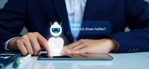 Geschäftsmann interagiert mit einem digitalen Assistenten auf einem Tablet, Sprechblase mit 'Hallo! Kann ich Ihnen helfen?'